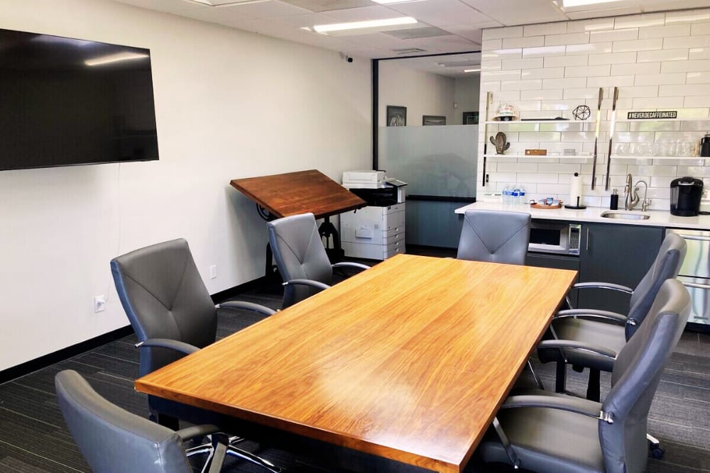 Image of Officer Interior with Desk, TV, and Small Kitchen