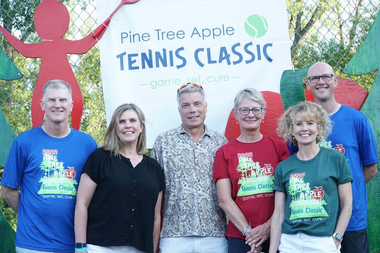 Six People Standing in Front of Pine Tree Apple Tennis Classic Game Set Cure